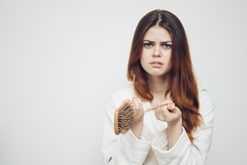 Female experiencing hair breakage before using CBD shampoo