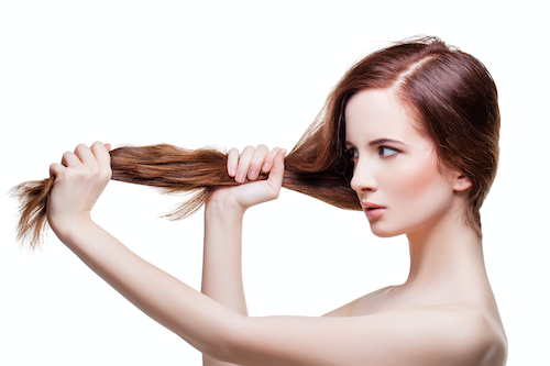 Girl pulling hair to test CBD hair care strength