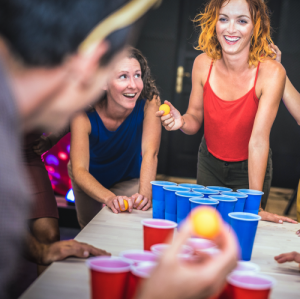 women playing bong pong at weed party