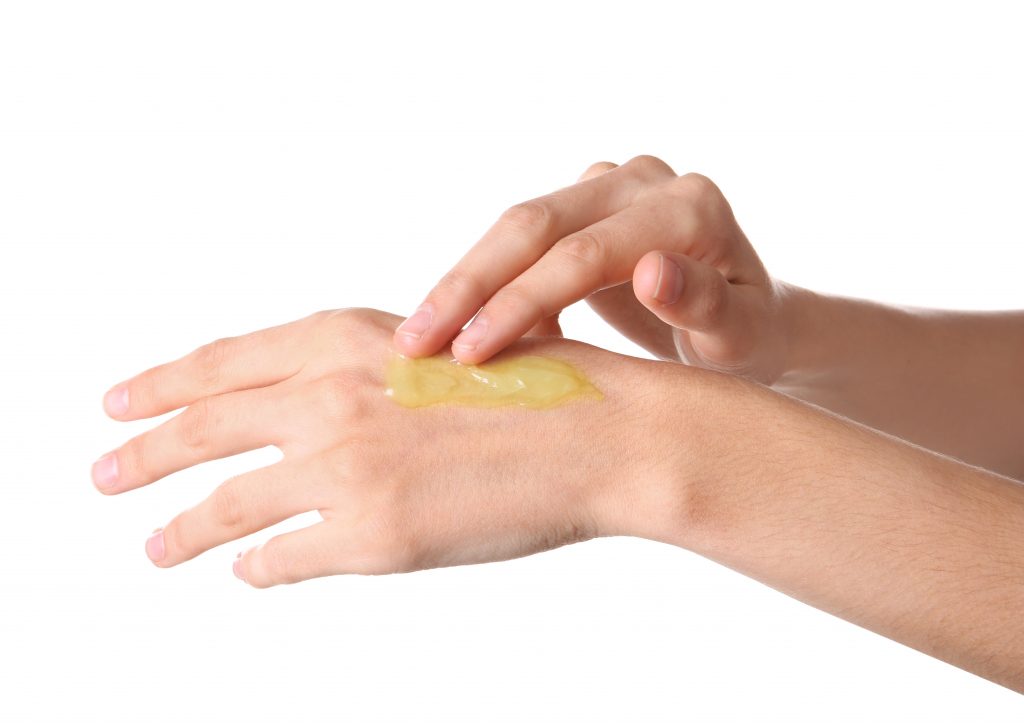 weed topical cream being applied to hand