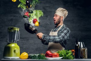 man cooking vegetables