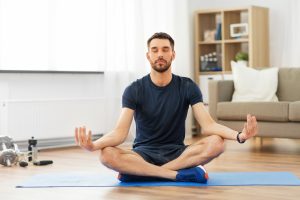 man practicing yoga at an at home cannabis retreat