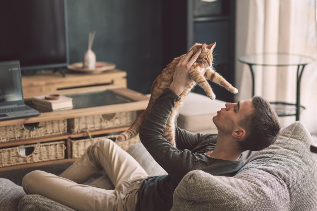 man holding cat for cbd oil for pets