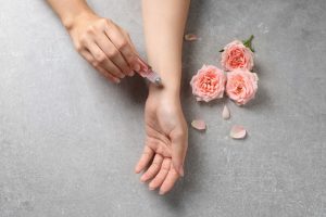 girl putting on weed perfume roller