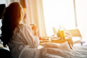 woman waking up at a weed friendly hotel